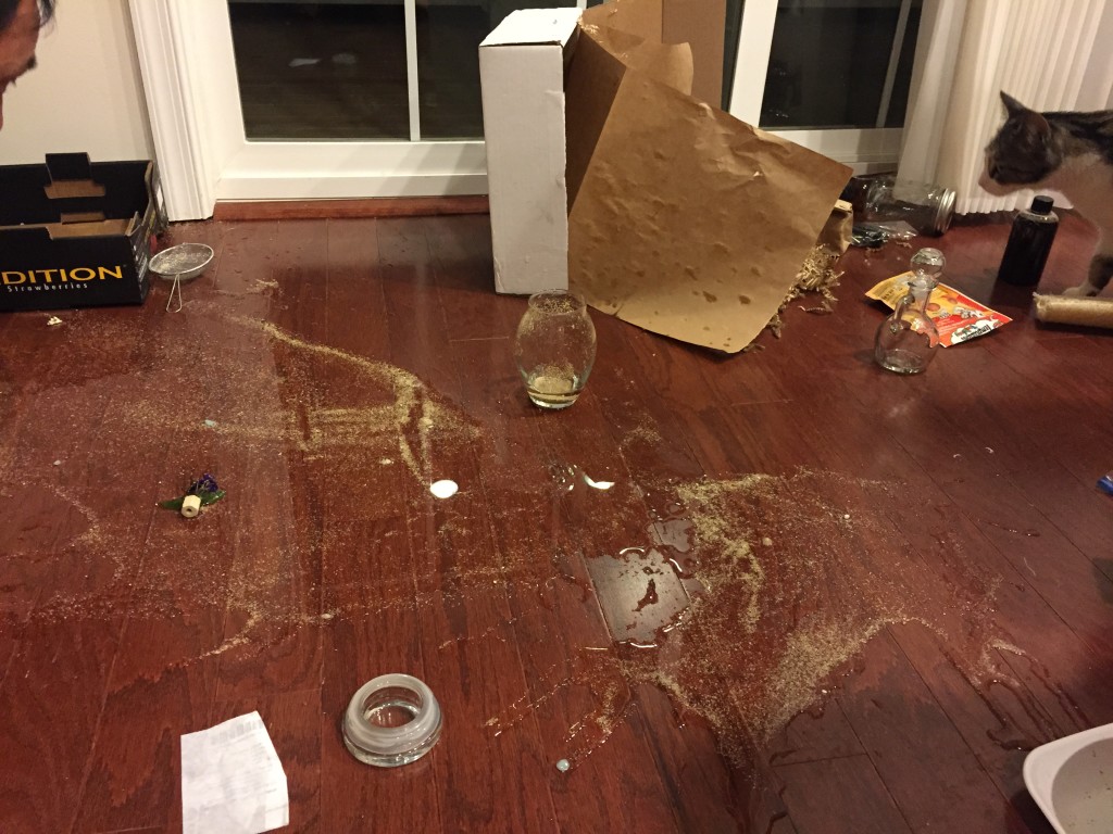 spilled water and sand on hardwood floor