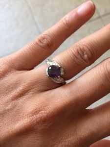 purple sapphire engagement ring on hand