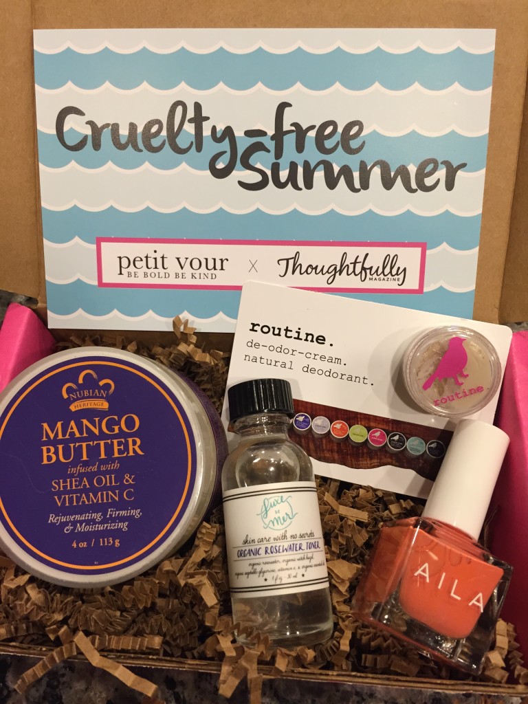 contents of petit vour july 2015 box with nubian heritage mango butter, luxe de mer toner, routine. de-odor-cream, aila nail lacquer, and info card with cruelty-free summer theme