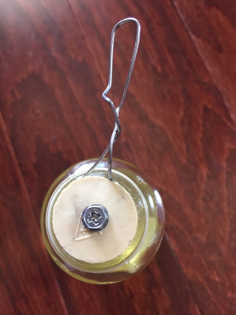 dani naturals reed diffuser bottle with nail trying to release stopper