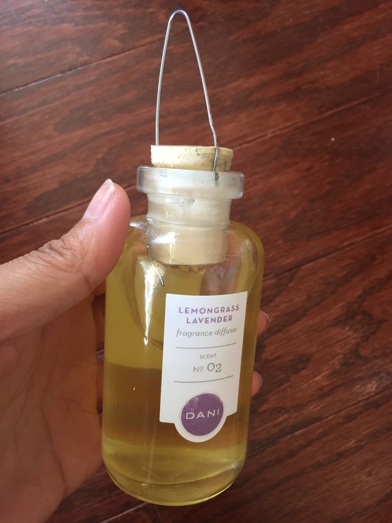 dani naturals reed diffuser bottle with paperclip inserted at two points to leverage popping out stopper