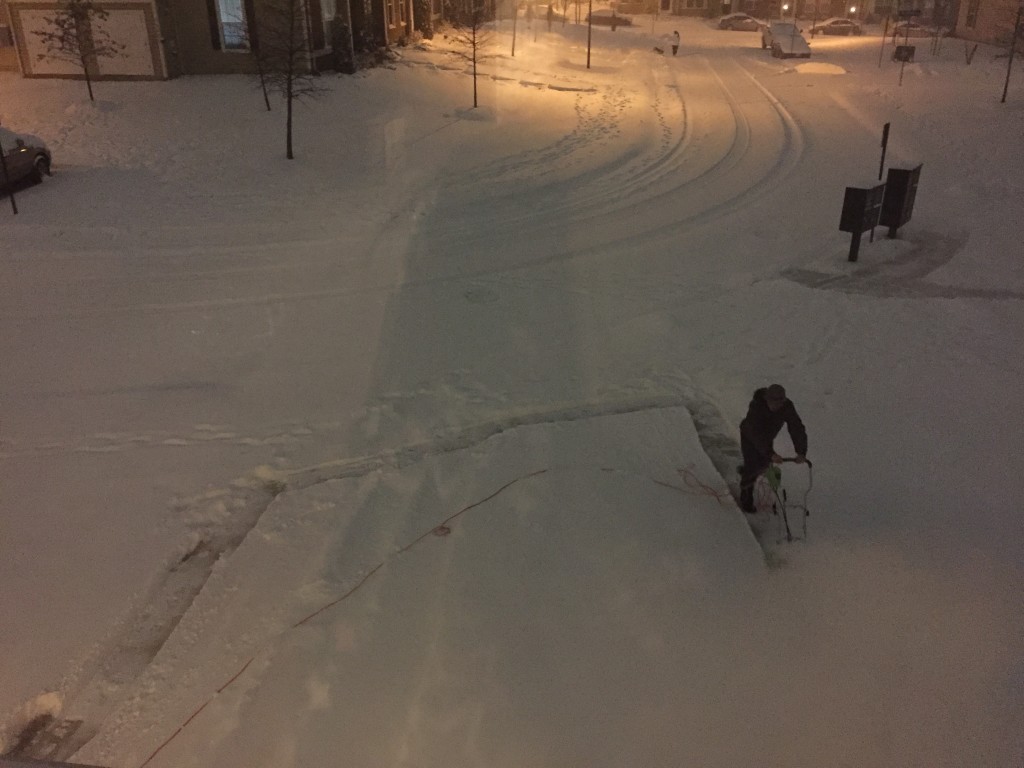 man pushing snowblower outside on driveway during blizzard 2016