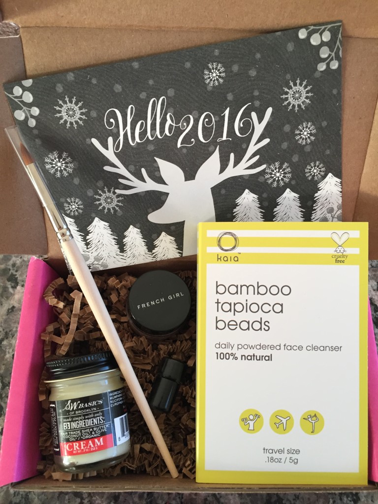contents of petit vour january 2016 box with hello 2016 theme and info card