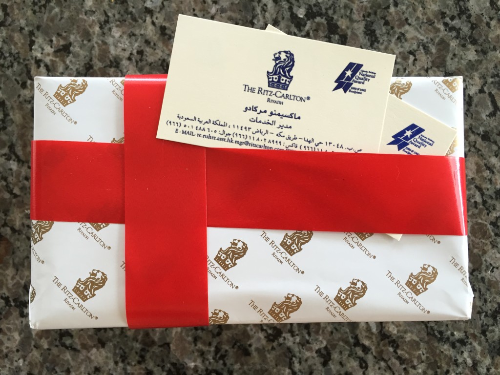 ritz-carlton gift box with white wrapping paper and red ribbon