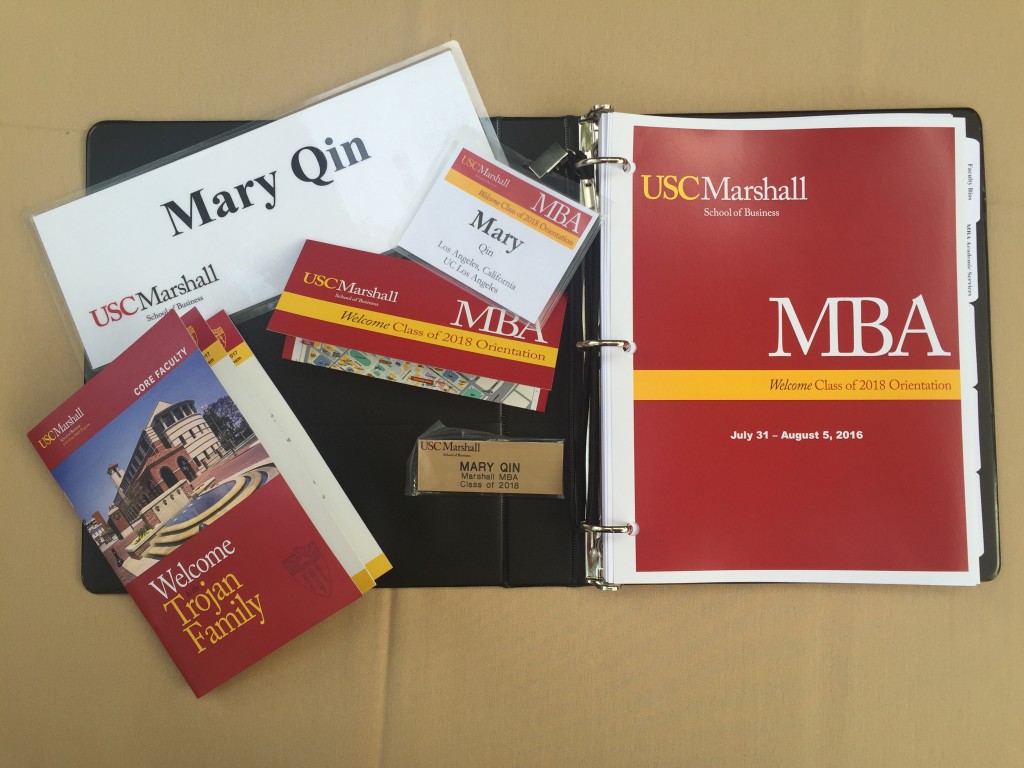 usc marshall mba orientation folder with name tags, schedules, and other documents