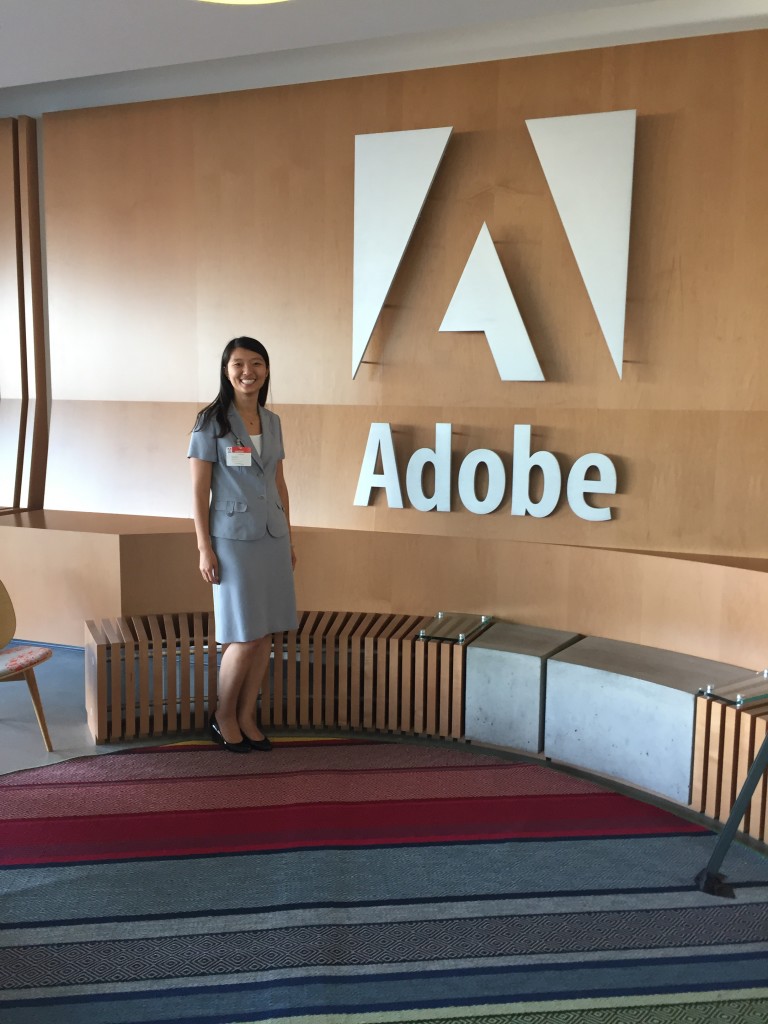 posing by entry of adobe headquarters