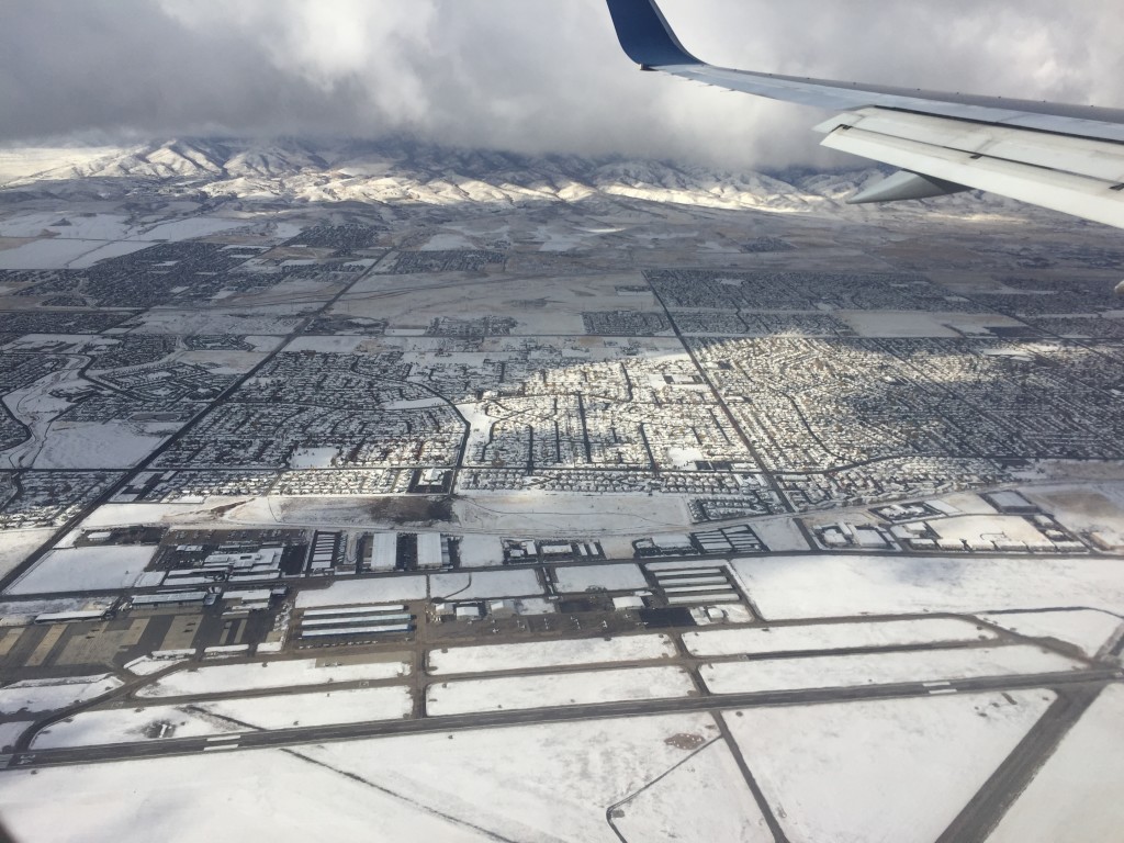 view of snow covering salt lake city from airplane landing