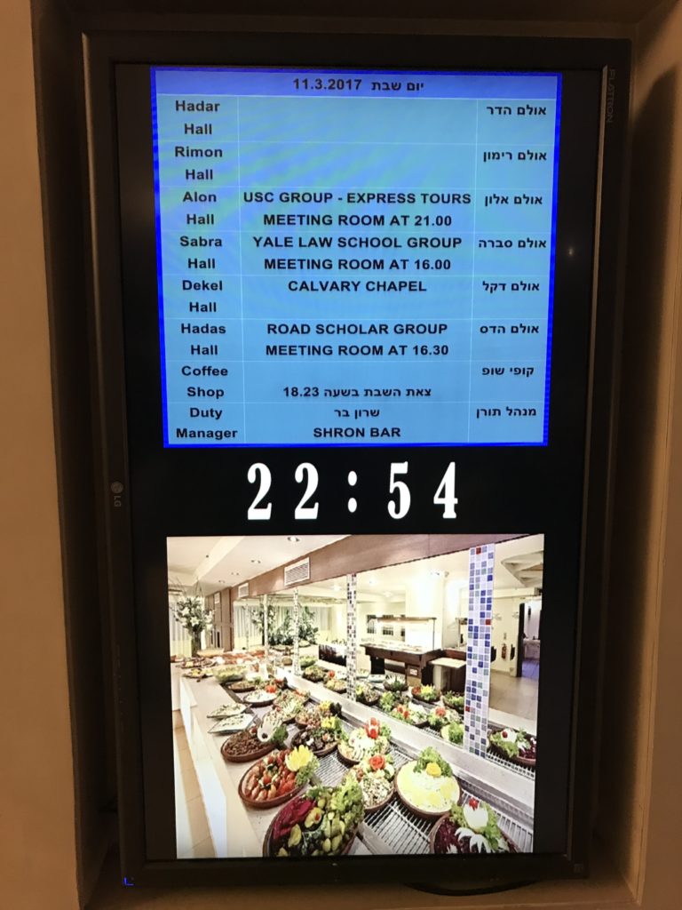 electronic display at hotel showing usc group meeting in alon hall