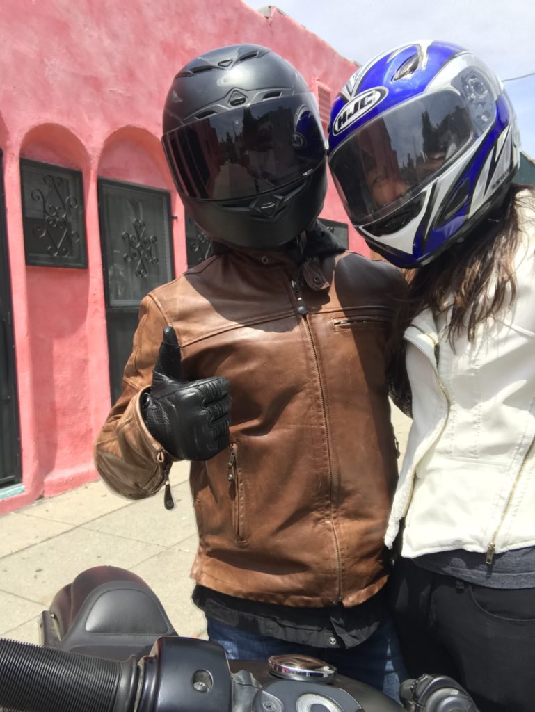 motorcycle riders with leather jackets and helmets